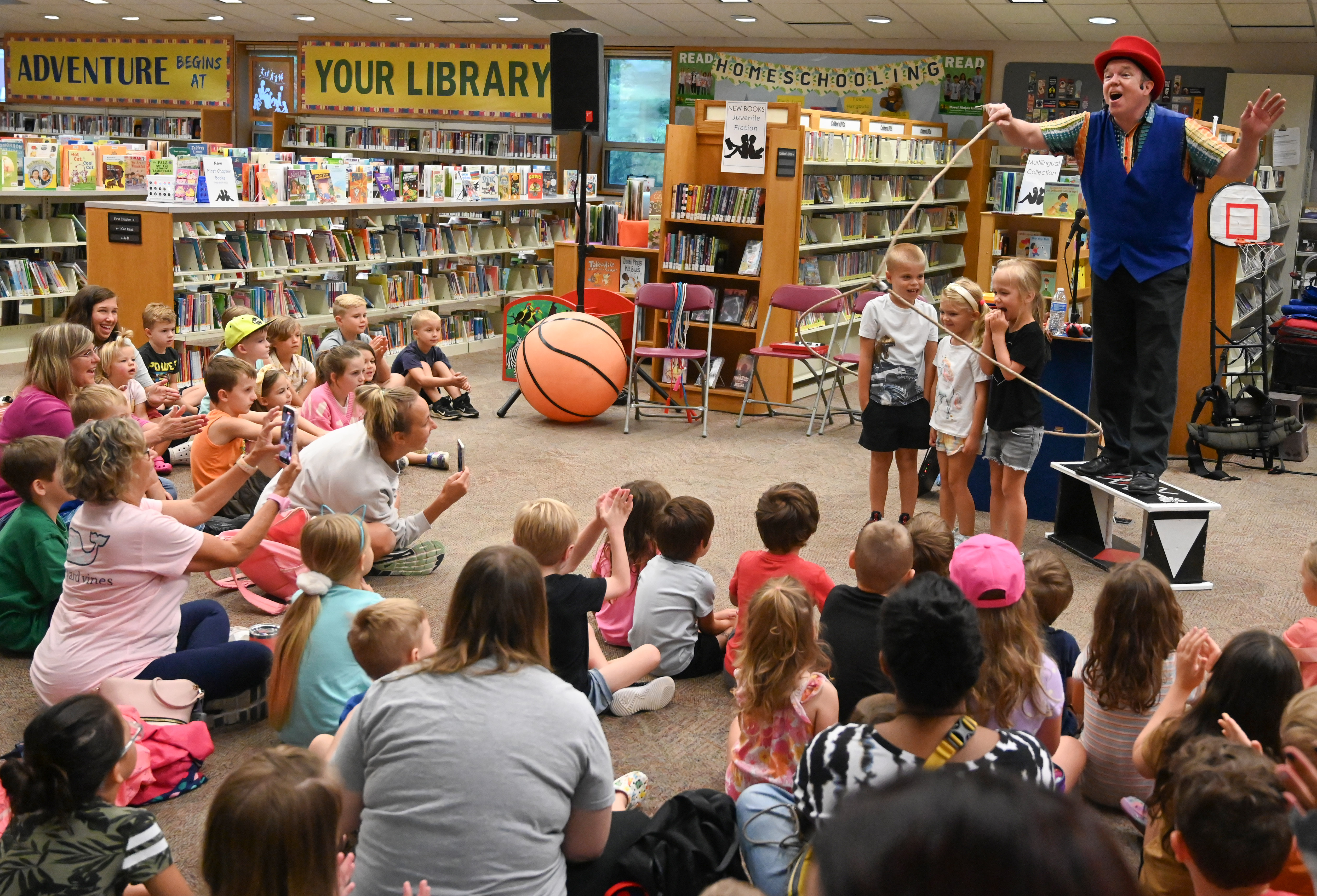 Gregory May teaches an audience about gyroscopic motion as he spins a lasso around three volunteers, part of his Circus Science act at the North Carroll Branch library on Thursday. May, a Columbia resident, combines science and circus tricks to educate and entertain her audiences through the background of a former Ringling Brothers circus performer Barnum and Bailey, a science teacher in Baltimore City and an instructor at Port Discovery. (Brian Krista/staff photo)