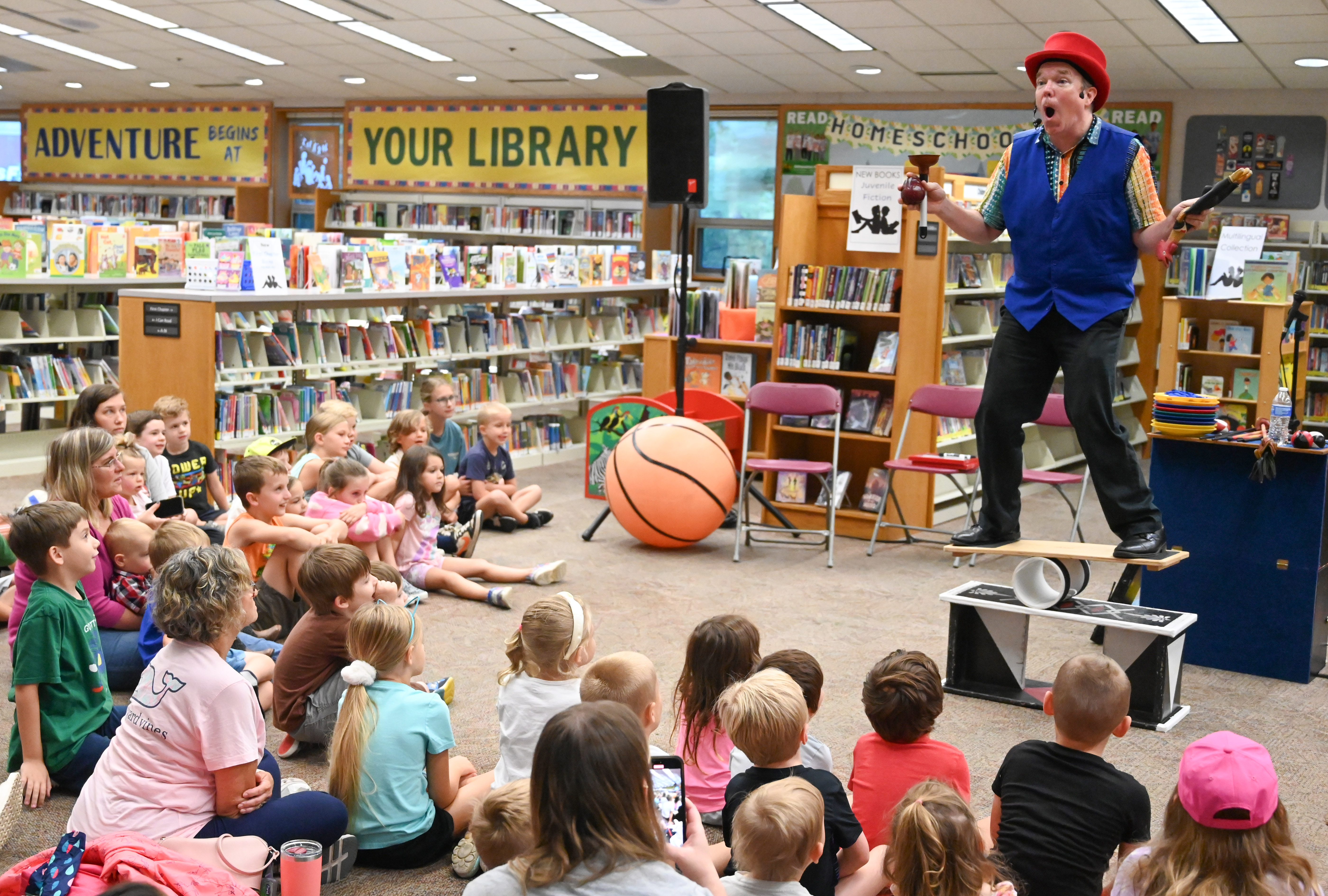 Gregory May performs a juggling and balancing routine as part of his Circus Science act at the North Carroll Branch library on Thursday. May, a Columbia resident, combines science and circus tricks to educate and entertain her audiences through the background of a former Ringling Brothers circus performer Barnum and Bailey, a science teacher in Baltimore City and an instructor at Port Discovery. (Brian Krista/staff photo)