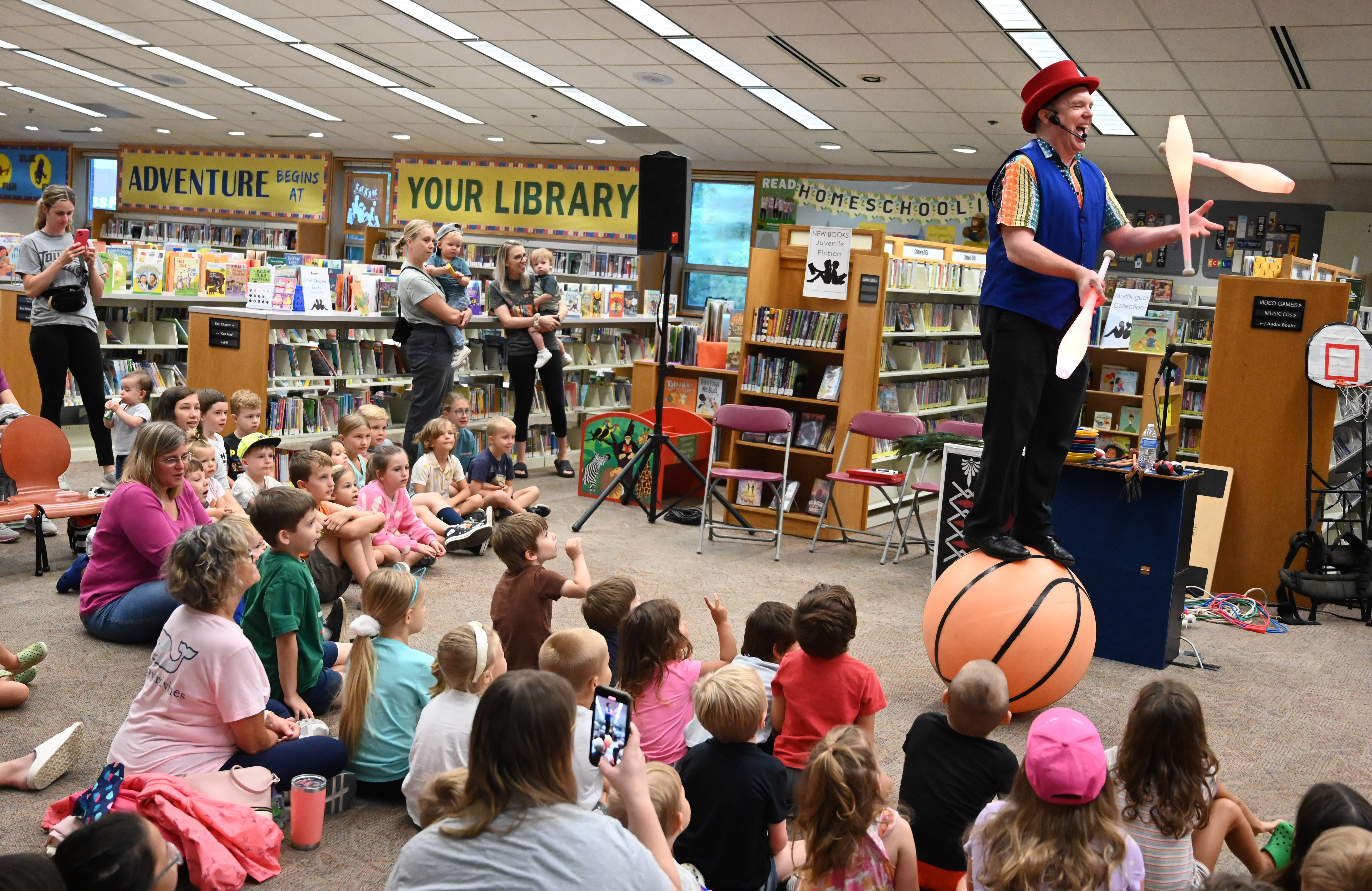 Gregory May performs a juggling and balancing routine as part of his Circus Science act at the North Carroll Branch library on Thursday. May, a Columbia resident, combines science and circus tricks to educate and entertain her audiences through the background of a former Ringling Brothers circus performer Barnum and Bailey, a science teacher in Baltimore City and an instructor at Port Discovery. (Brian Krista/staff photo)