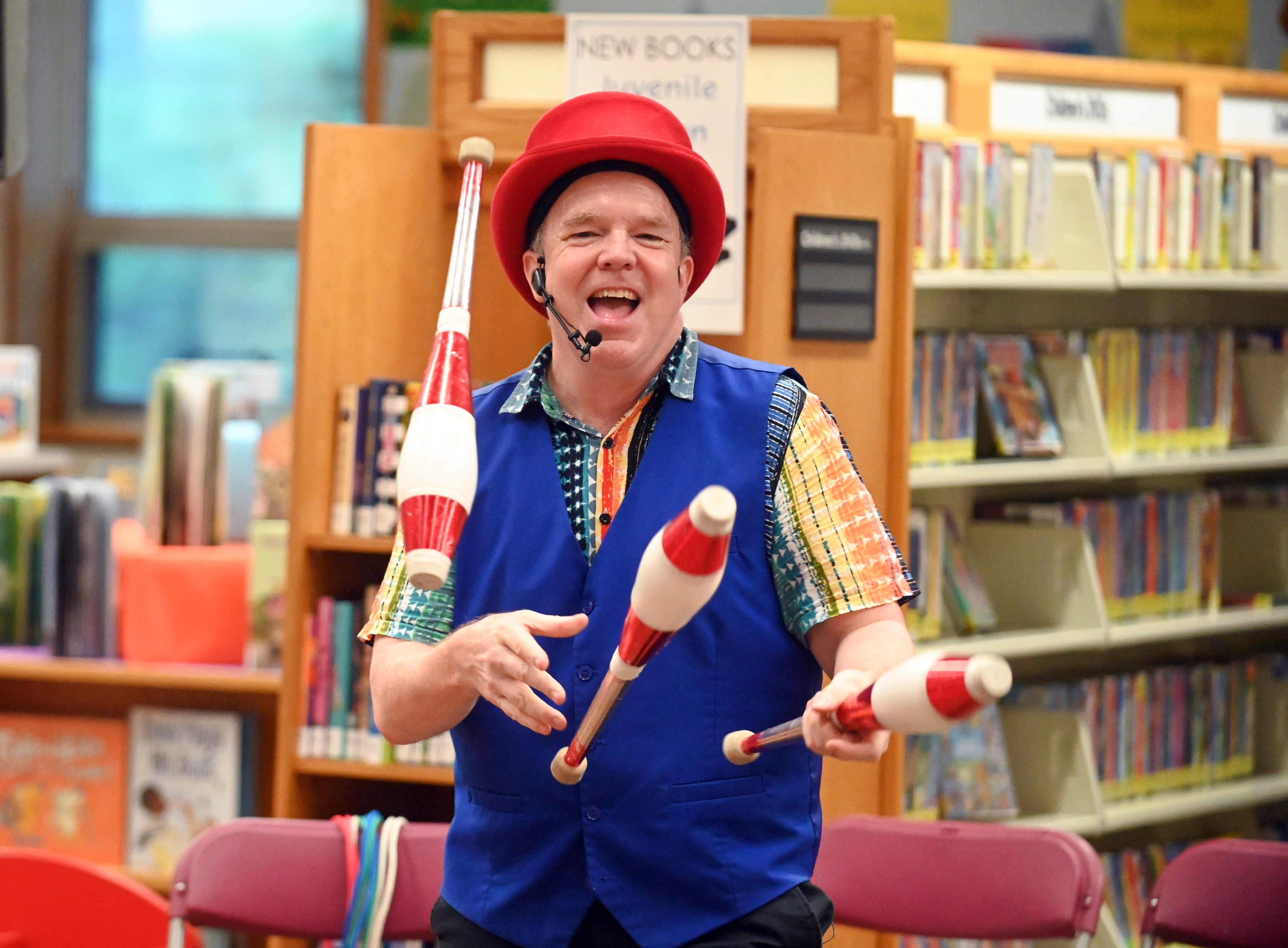 Gregory May performs a juggling routine, part of his Circus Science act at the North Carroll Branch library on Thursday. May, a Columbia resident, combines science and circus tricks to educate and entertain her audiences through the background of a former Ringling Brothers circus performer Barnum and Bailey, a science teacher in Baltimore City and an instructor at Port Discovery. (Brian Krista/staff photo)