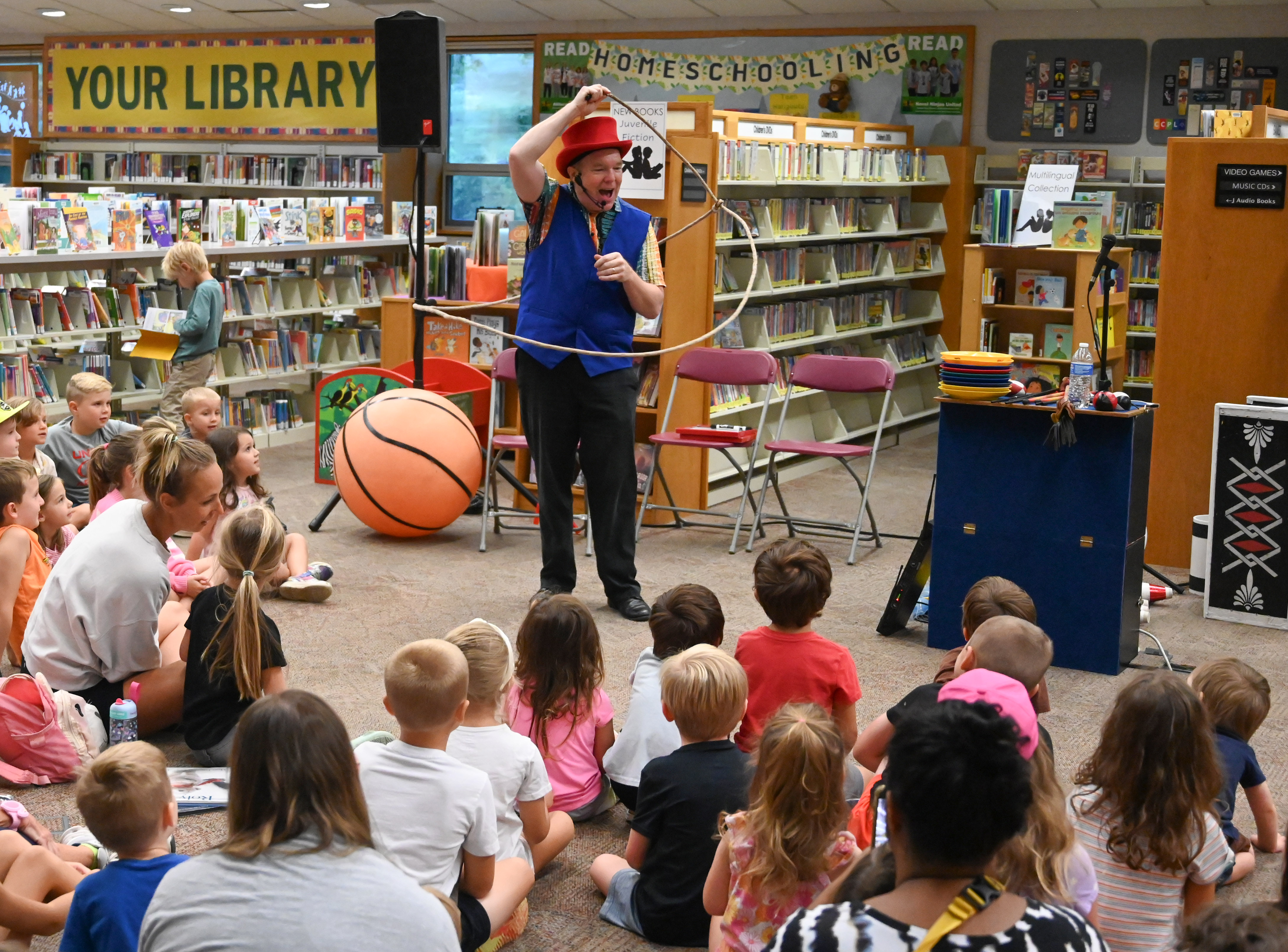 Gregory May teaches an audience about gyroscopic motion as he spins a lasso around, part of his Circus Science act at the North Carroll Branch library on Thursday. May, a Columbia resident, combines science and circus tricks to educate and entertain her audiences through the background of a former Ringling Brothers circus performer Barnum and Bailey, a science teacher in Baltimore City and an instructor at Port Discovery. (Brian Krista/staff photo)