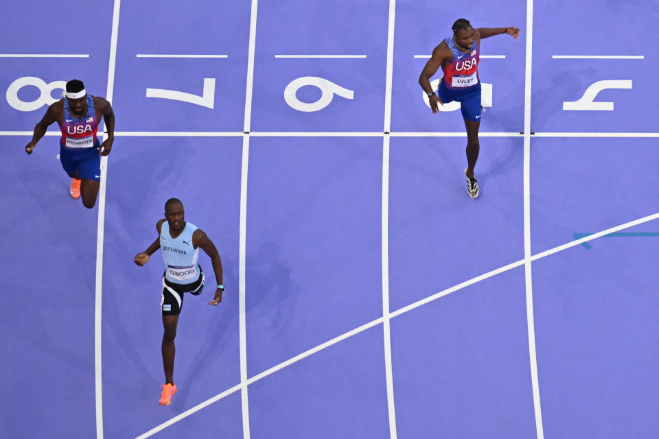 Botswana's Letsile Tebogo (2ndL) wins the final race ahead of USA's Noah Lyles (R) and US's Kenneth Bednarek (Bottom) to win the men's 200m athletics at the Paris 2024 Olympic Games at the Stade de France in Saint-Denis, north of Paris, on August 8, 2024. (Photo by Jewel SAMAD/AFP) (Photo by JEWEL SAMAD/AFP via Getty Images)