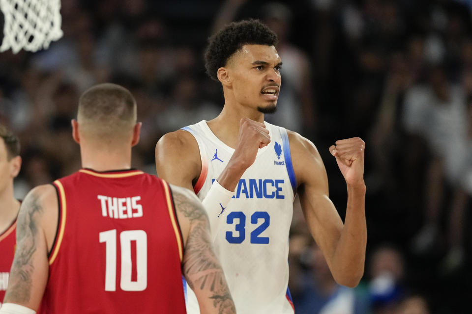 Victor Wembanyama (32), of France celebrates a basket against Germany during the men's basketball semifinals match at Bercy Arena at the 2024 Summer Olympics, Thursday, Aug. 8, 2024, Paris, France. (AP Photo/Mark J. Terrill)